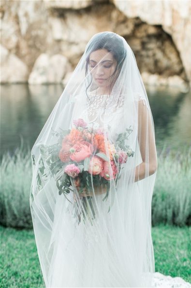 Bride wearing veil and holding flowers