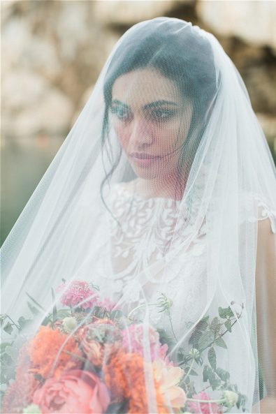 Bride wearing veil and looking in front of her