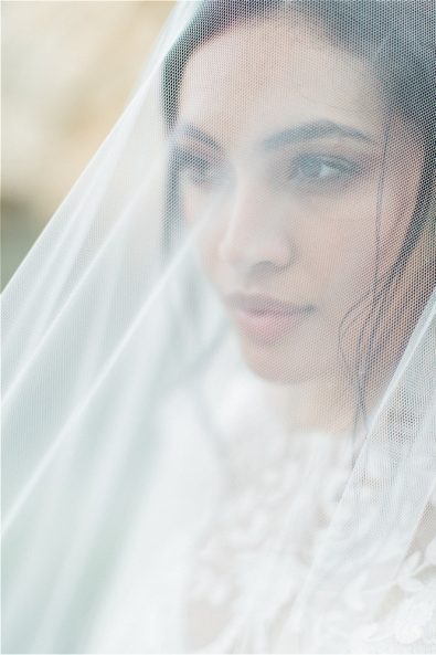 Close up of brunette bride wearing veil