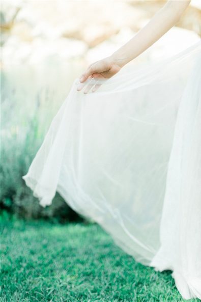 Bride's hand holding wedding veil