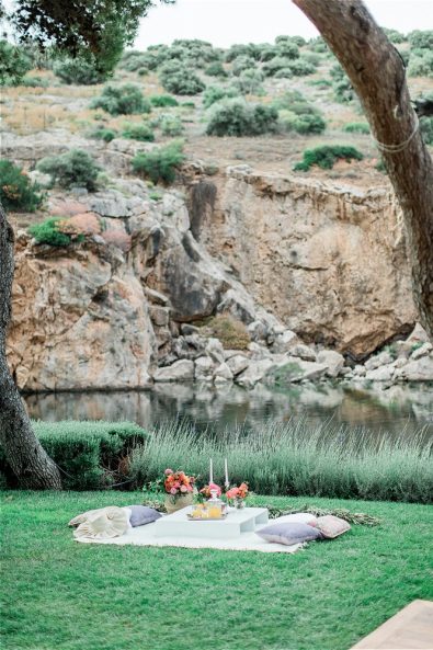Zoomed out photo of picnic cloth in front of Lake Vouliagmeni