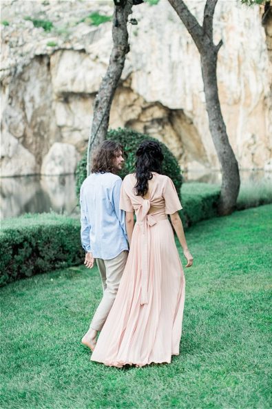 Bride and Groom walking on grass at Late Vouliagmeni