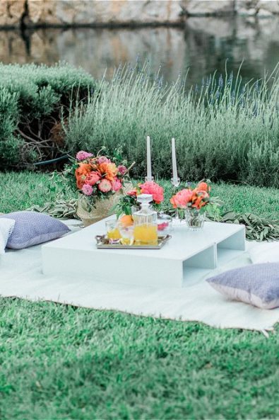 Picninc with pillows, flowers and candles setup for an elopement in Greece