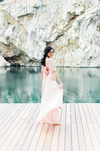 Bride posing in front of Lake Vouliagmeni