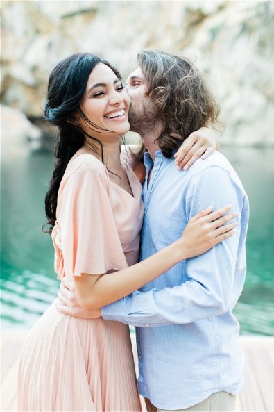 Groom kissing bride on cheek
