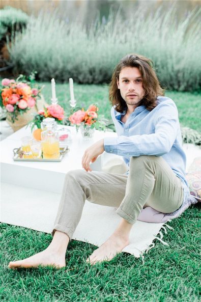 Barefoot Groom sitting on picnic cloth