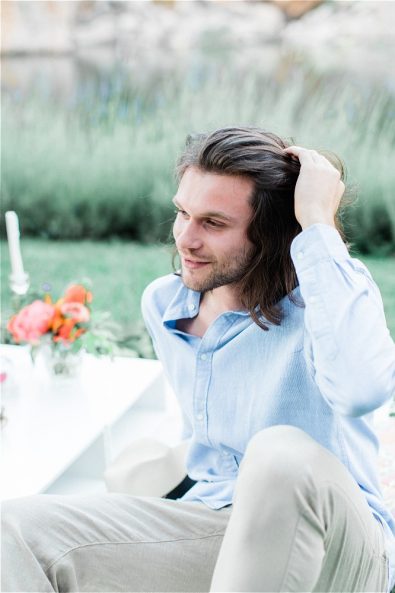 Groom fixing his har at his elopement in Greece