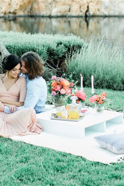 Groom holding bride on picnic cloth at their elopement in Greece