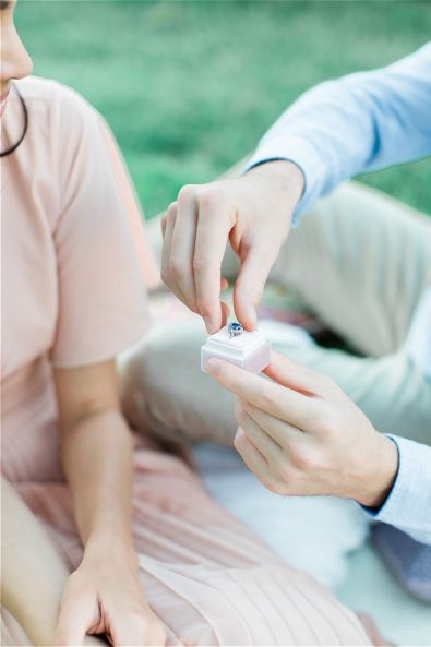 Groom holding wedding ring