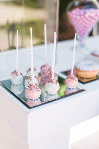 Chocolate cake pops dipped in blush pink and white chocolate with rosegold and white sprinkles.
