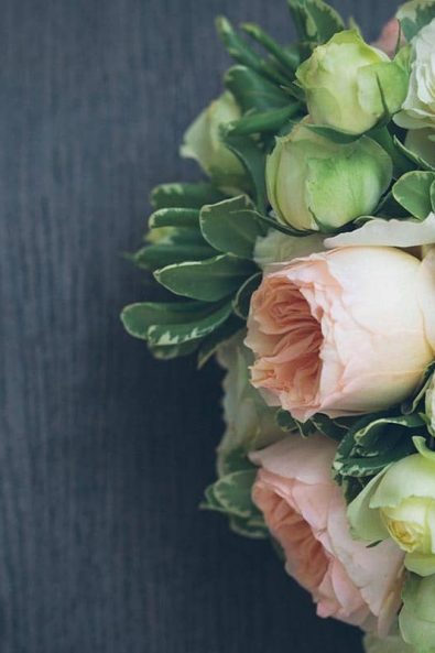 Flower arrangement with white and blush pink English roses.