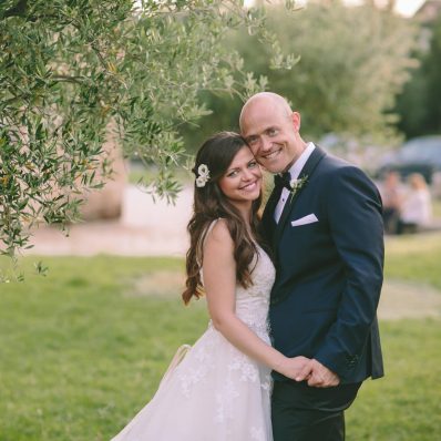 Bride and groom posing together smiling.