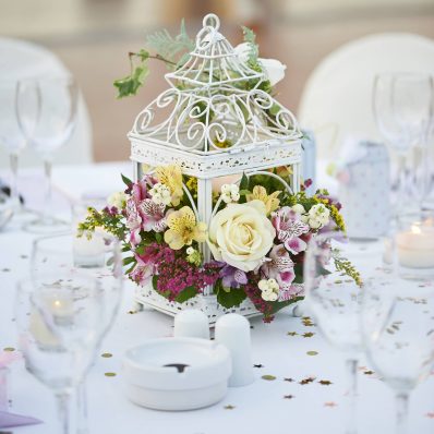Spring inspired iron flower cage with roses, alstroemeria and wild flowers.