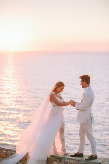 Couple getting married in Greece in front of sunset