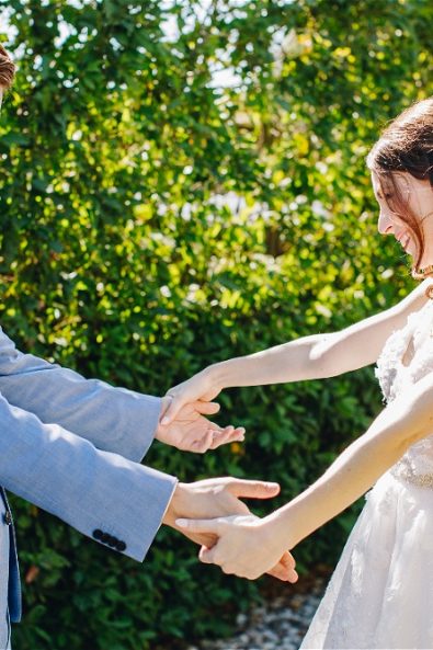 Groom and bride holding hands
