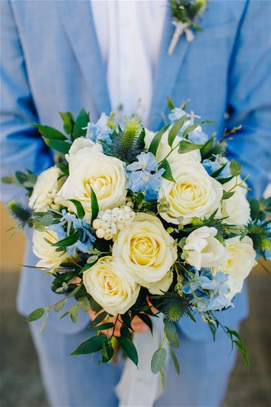 Groom holding flowers