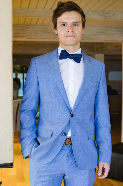 Front view of groom with blue tuxedo