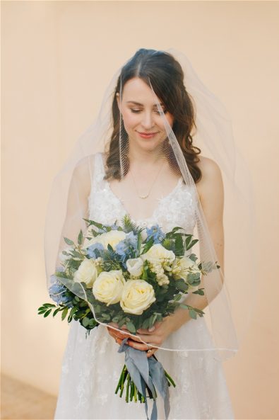 Bride with veil holding flowers