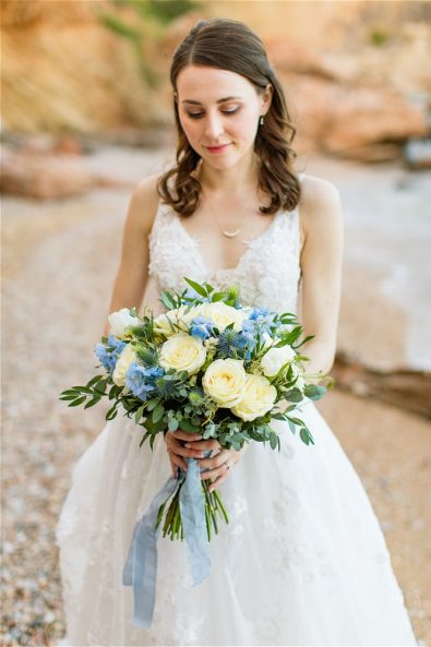 Bride in white dress holding flowers