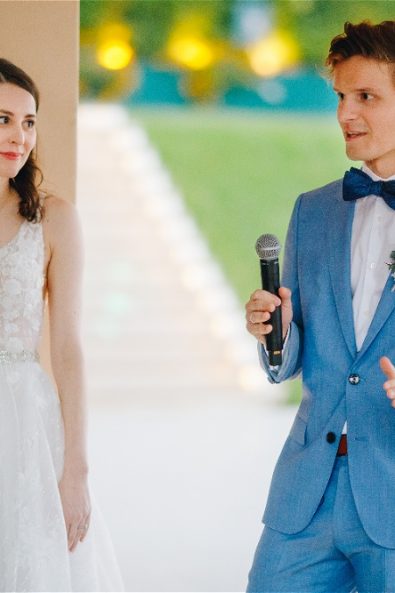 groom giving speech with bride next to him