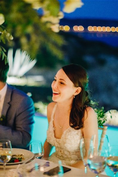 bride laughing at table next to groom