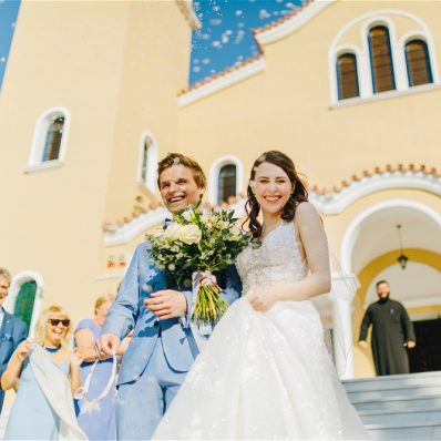 Destination wedding in Athens Riviera couple walking down church stairs