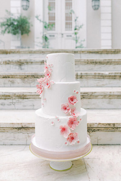 Wedding cake decorated with pink sugar flowers
