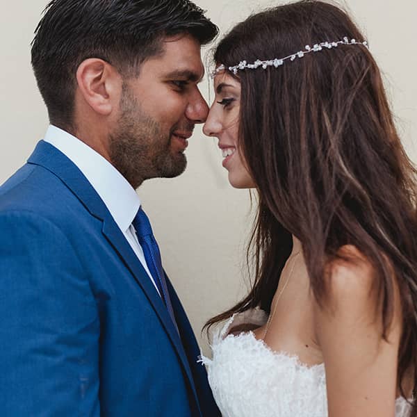 Where professionalism meets creativity: Boho bride with jewelled headpiece and groom with blue suit.