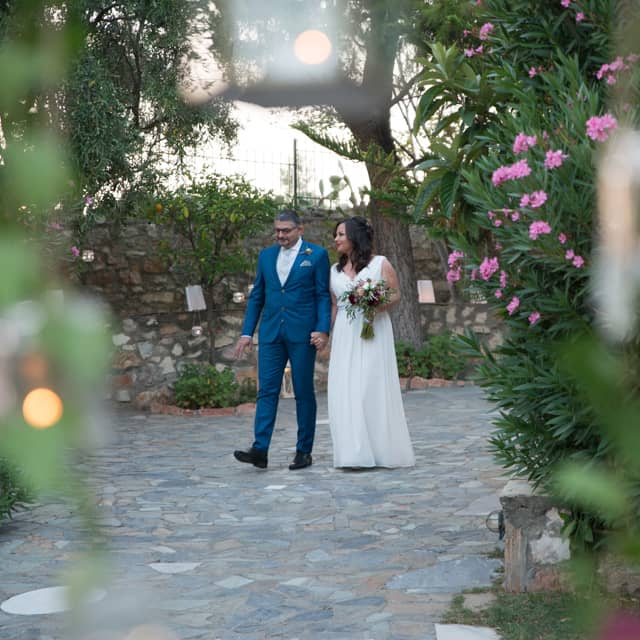 Bride and groom walking hand in hand after their wedding ceremony.