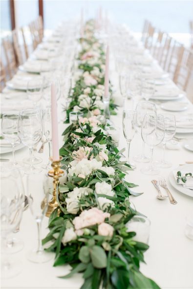 Long table setup with flowers and dinnerware