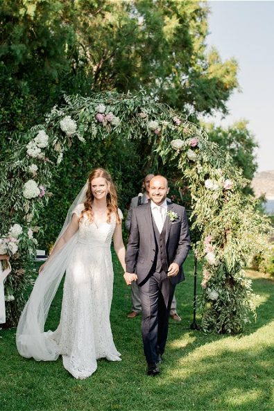 Bride and Groom holding hands at garden