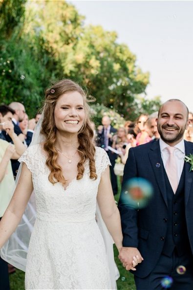Bride and groom holding hands at destination wedding in Athens Greece