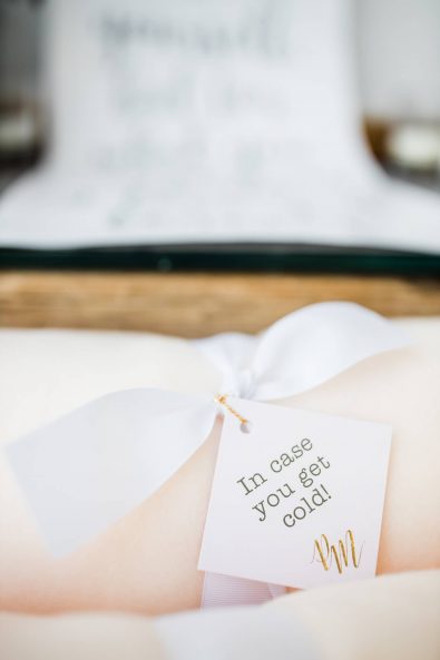 Close up shot of comfy soft blush blankets for wedding guests.