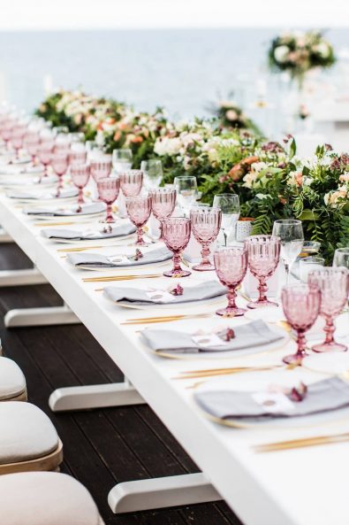 Romantic blush, gold and mauve table setting with pink flower centrepiece for a late November destination wedding in Greece.