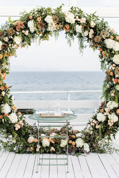 Round flower decorated wedding arch for a destination wedding in Greece.