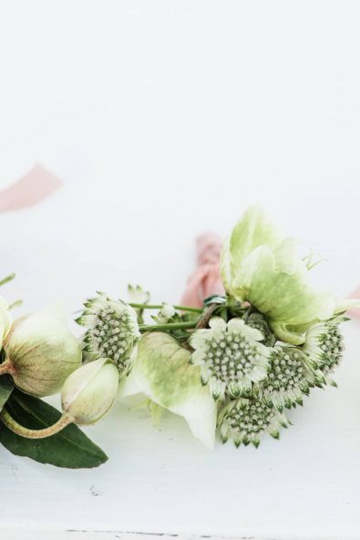 Intricate white, pink and mauve flower boutonnieres for the groom and the groomsmen.