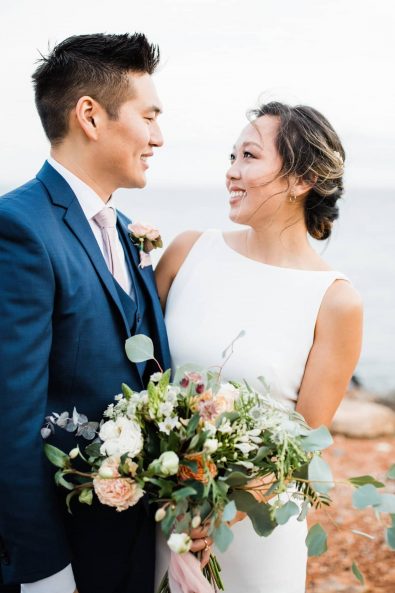 Portrait of bride and groom on the beach for a late autumn blush and gold destination wedding in Greece.