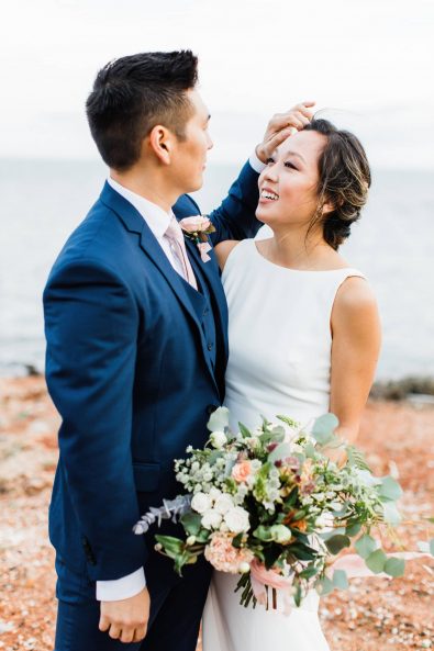 Destination wedding in Greece - The Korean groom caressing the hair of his bride looking lovingly into her eyes.