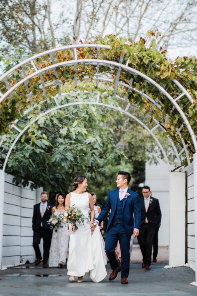 The bride, groom, groomsmen, and bridesmaids entering the wedding venue.