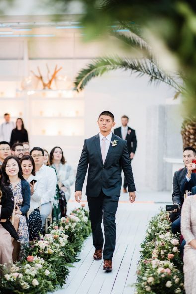 Groomsman walking down the aisle.