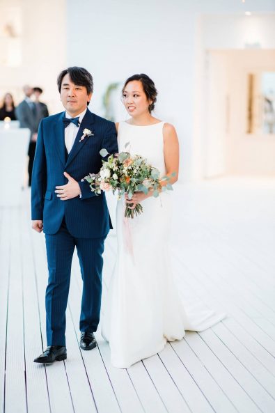 Destination wedding in Greece - The father and his daughter walking down the aisle to give her away to her groom.