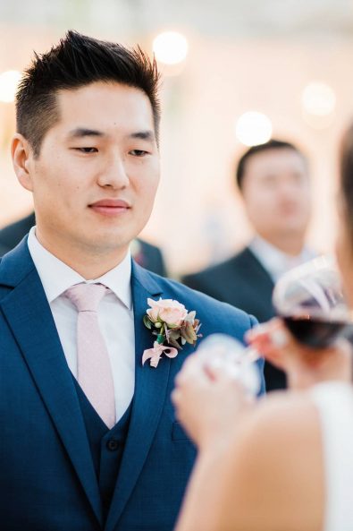 Groom looking lovingly at his bride while they are getting married.