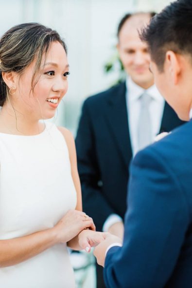 Bride and groom exchanging their wedding rings at their wedding ceremony.