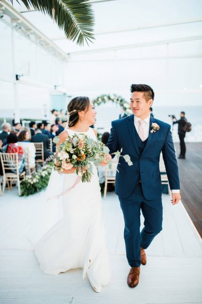 Bride and groom leaving after their wedding ceremony.