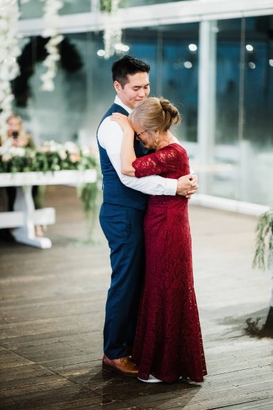 The groom and his mother sharing an emotional dance at his wedding reception.