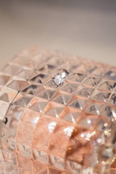 Detail shot of diamond and white gold bridal earrings.
