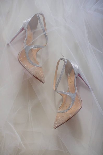 Silver mesh Louboutin wedding shoes and a white tulle veil.
