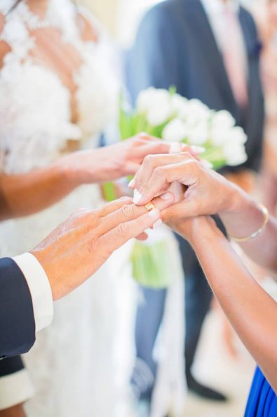 The best woman changes the couple's wedding rings at a greek orthodox wedding ceremony at a destination wedding in athenian riviera.