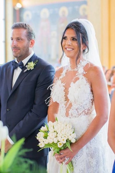 Shot of the Bride and groom, best man and maid of honor standing on the altar at a greek orthodox destination wedding in athenian riviera ceremony in Greece.