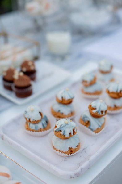 Marbled grey and white Religieuse french desserts on a marble serving tray for a destination wedding in athenian riviera.